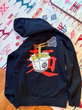 Lacrosse Black Hoodie with Ramen and Lacrosse sticks Graphic